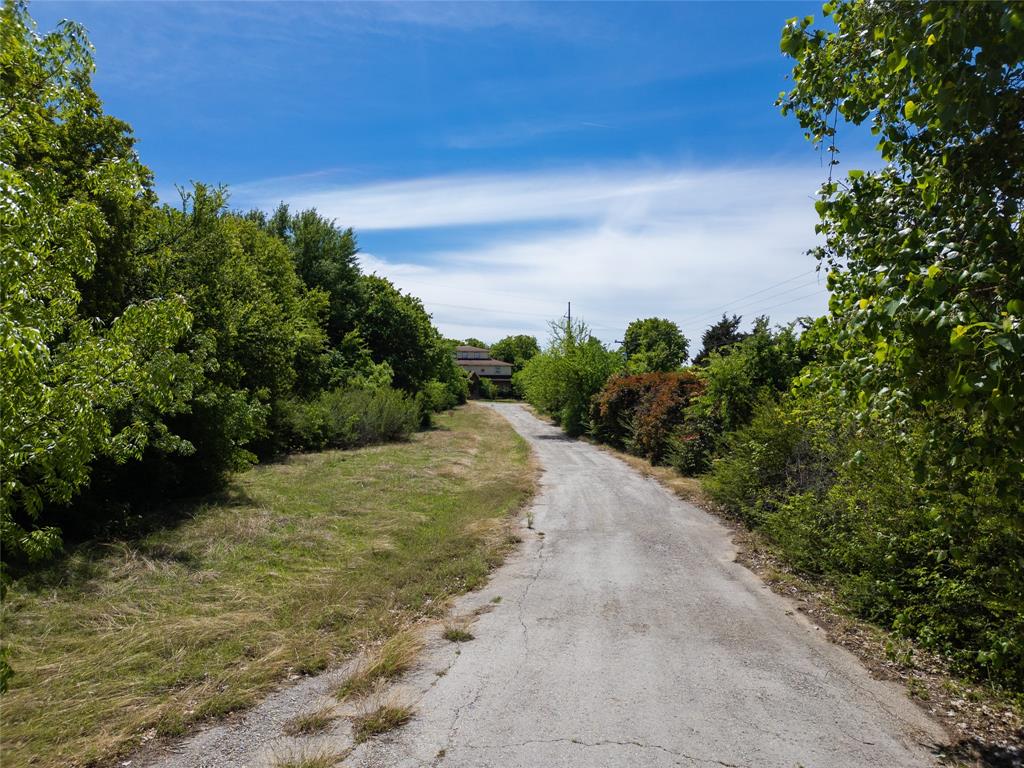 2900 Robinson Road Denton, TX 76210 - Photo 30 of 33 Paved driveway surrounded by mature trees and natural vegetation