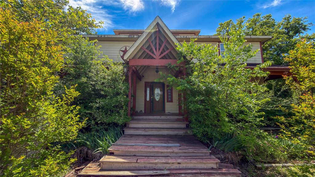 2900 Robinson Road Denton, TX 76210 - Photo 5 of 33 Gabled entry porch with red-toned wood accents and a dual-door entrance