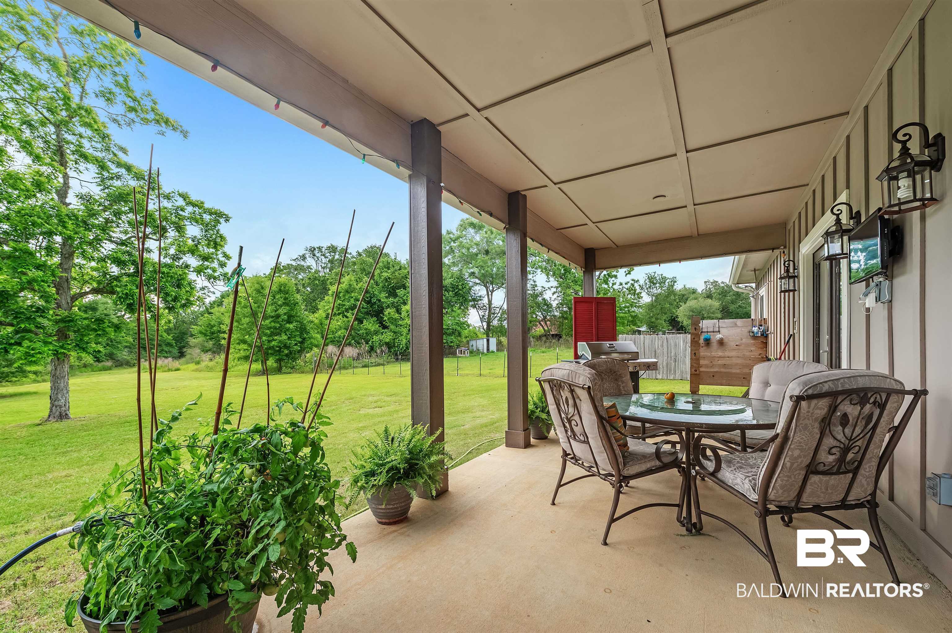 13827 County Road 83 Elberta, AL 36530 - Photo 11 of 38 View of patio with outdoor dining space and view of wooded area