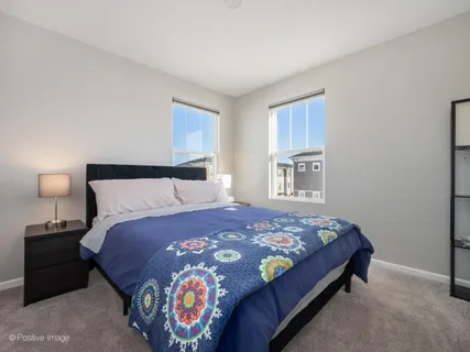 a bedroom with a bed and a lamp