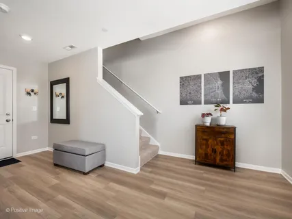 a living room with furniture and a hallway