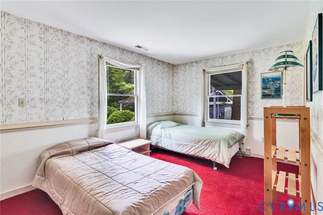142 Bridge Lane Reedville, VA 22539 - Photo 11 of 56 a bedroom with bed and wooden floor