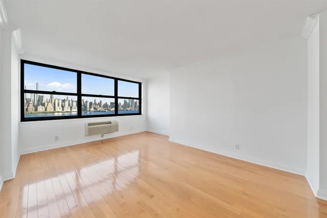 a view of an empty room and wooden floor