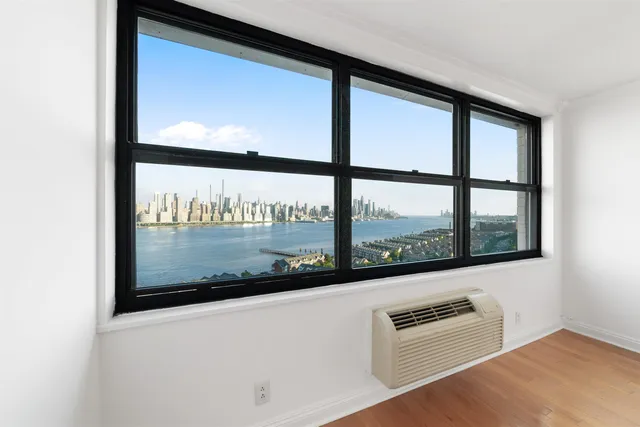 a view of an empty room and wooden floor