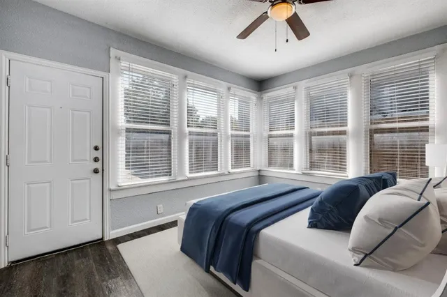 a spacious bedroom with a bed and glass window