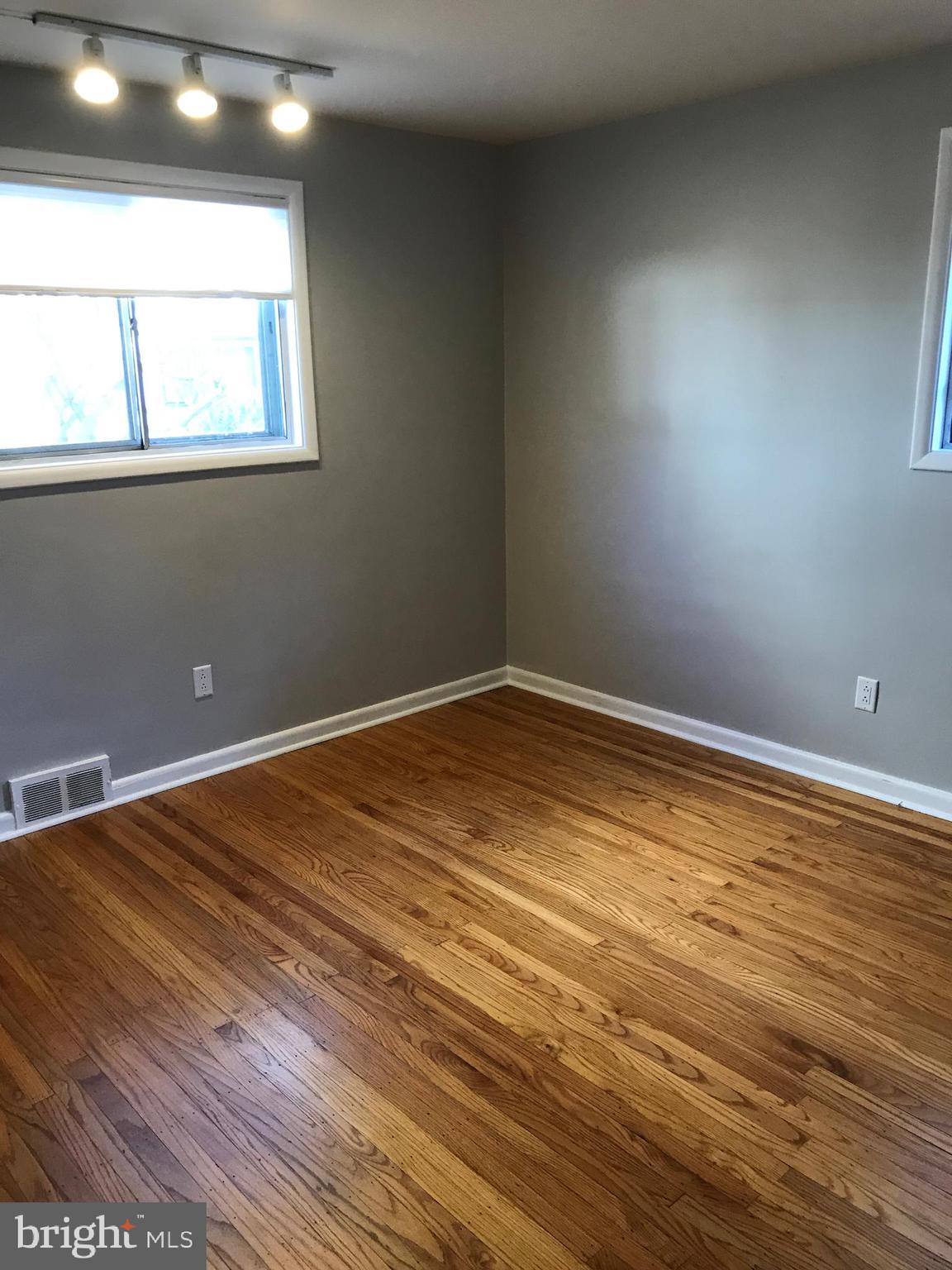 720 Yale Road Bala Cynwyd, PA 19004 - Photo 12 of 25 an empty room with wooden floor and windows