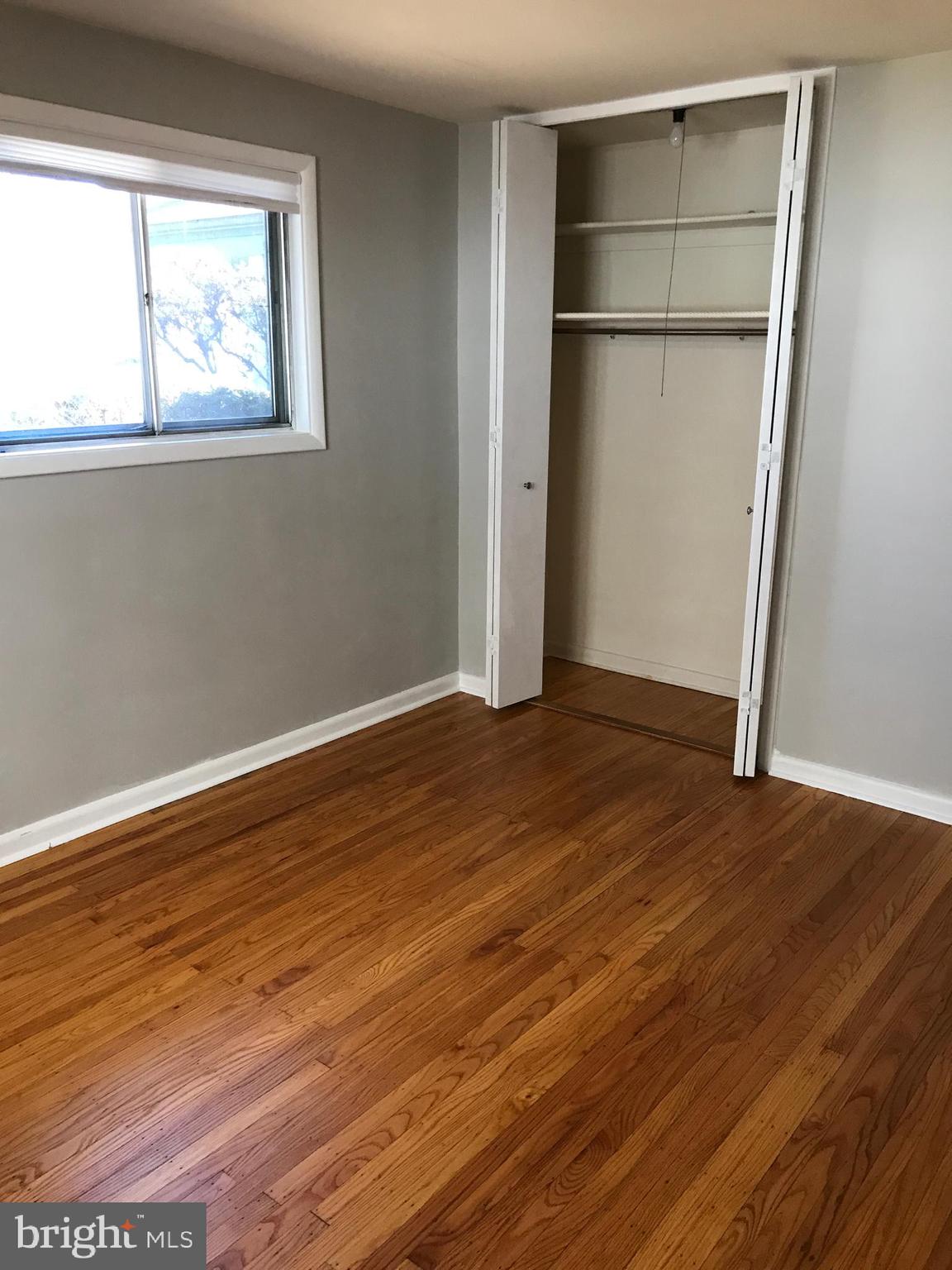 720 Yale Road Bala Cynwyd, PA 19004 - Photo 13 of 25 an empty room with wooden floor and a window