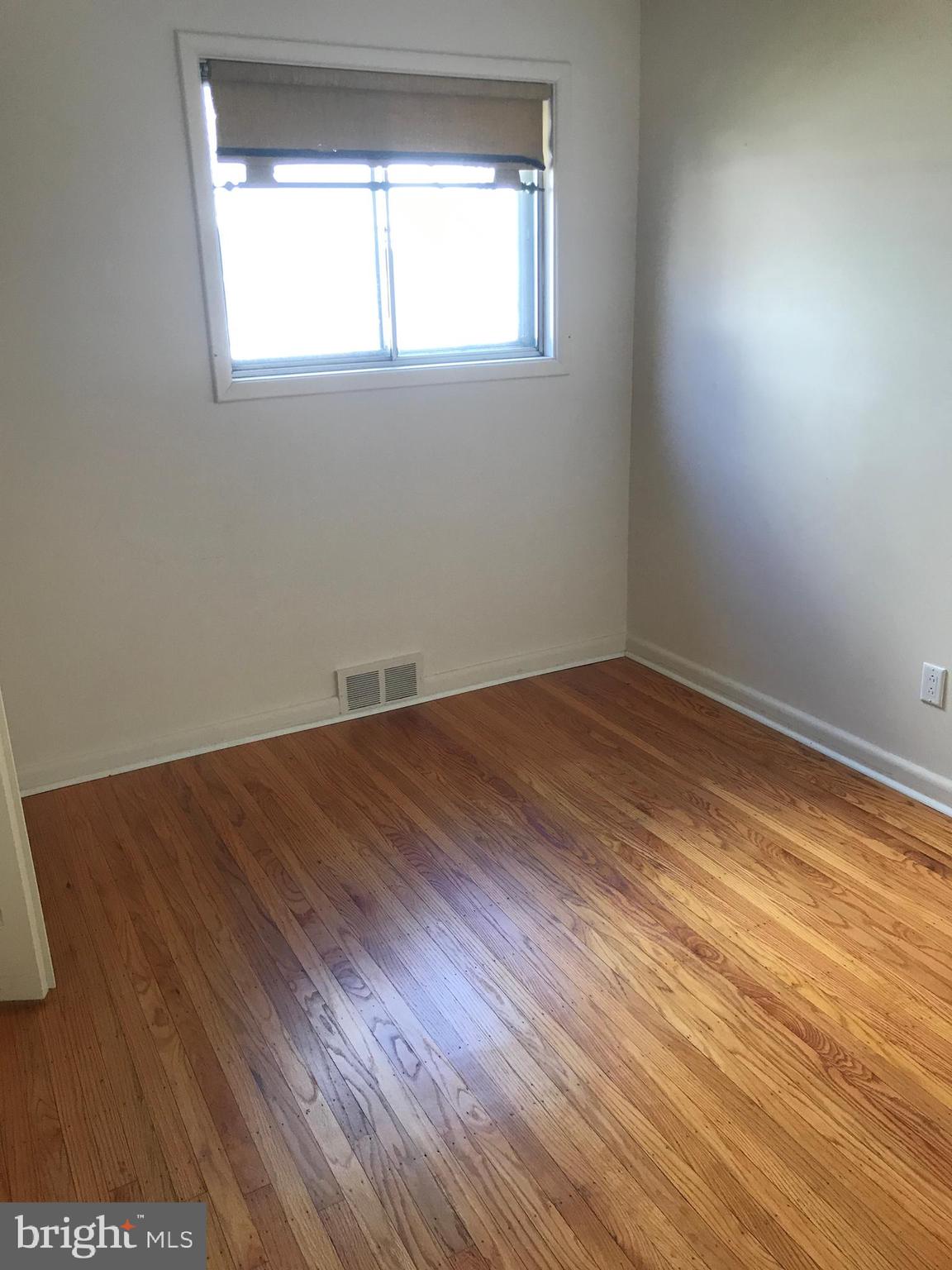 720 Yale Road Bala Cynwyd, PA 19004 - Photo 15 of 25 an empty room with wooden floor and windows