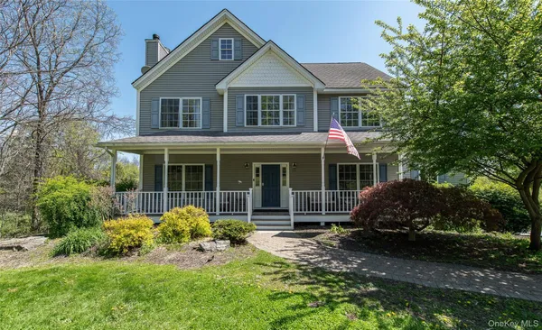 a front view of a house with a garden and porch