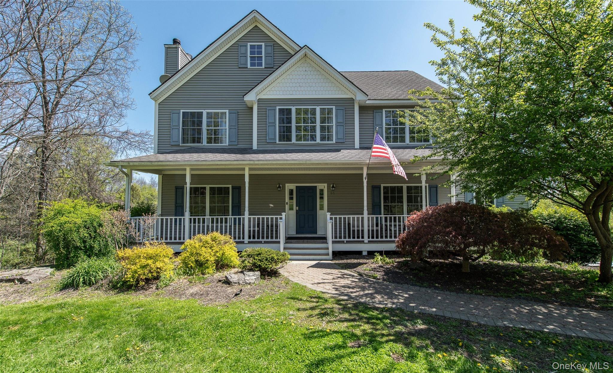 66 Gretna Road Pleasant Valley, NY 12569 - Photo 1 of 37 a front view of a house with a garden and porch