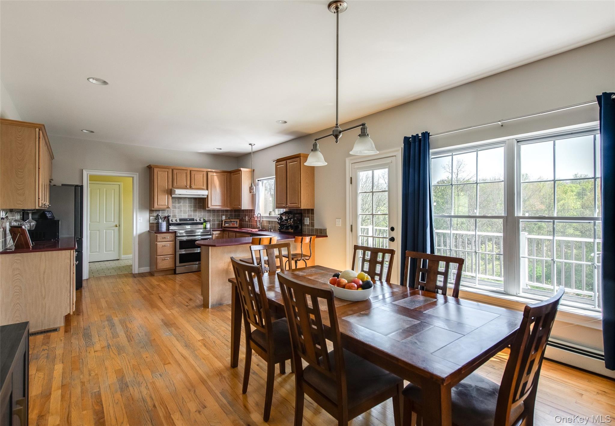 66 Gretna Road Pleasant Valley, NY 12569 - Photo 13 of 37 a view of a dining room and livingroom with furniture wooden floor a chandelier