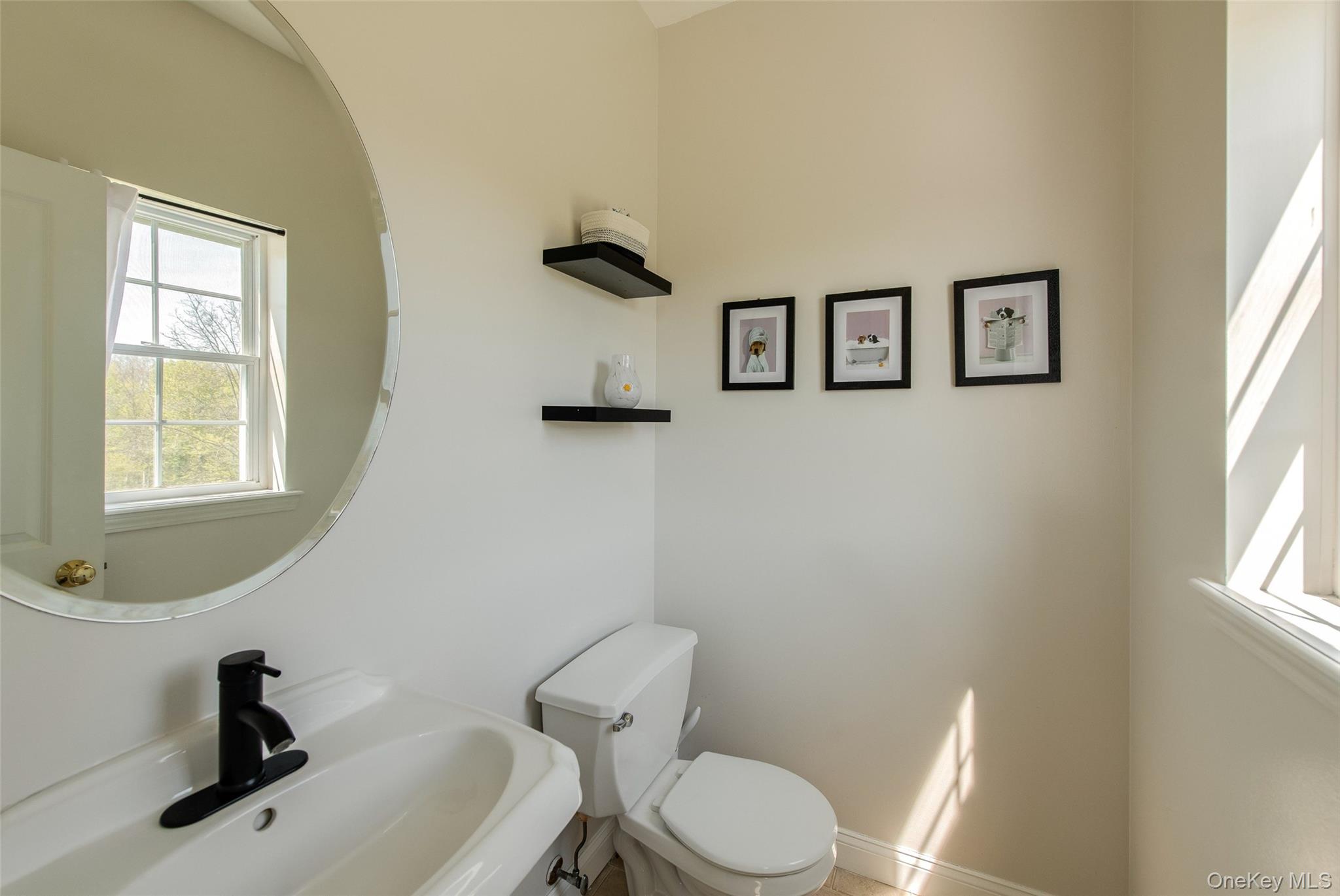 66 Gretna Road Pleasant Valley, NY 12569 - Photo 17 of 37 a bathroom with a toilet sink a window and mirror