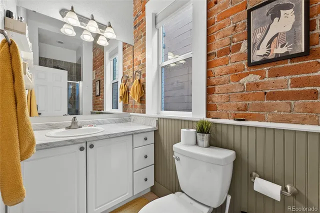 a bathroom with a toilet a sink and mirror