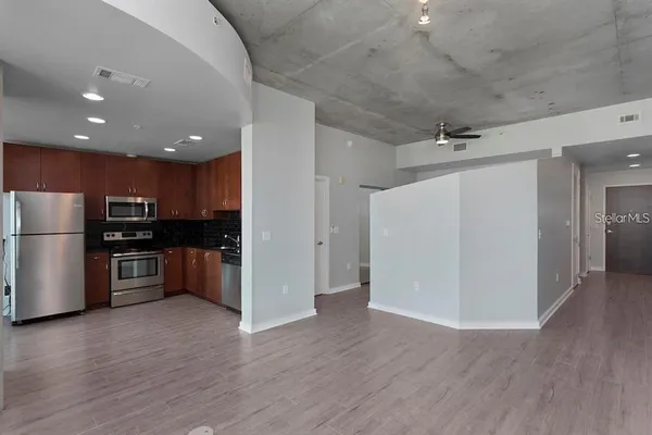 a kitchen with stainless steel appliances a refrigerator and a stove top oven