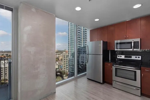 a kitchen with stainless steel appliances a refrigerator and a stove top oven