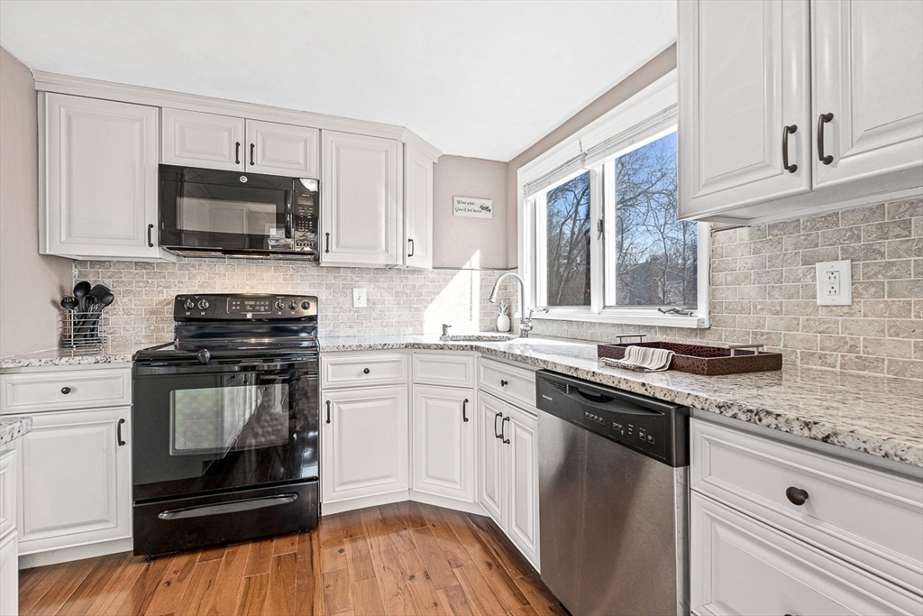80 Neal Street Malden, MA 02148 - Photo 11 of 39 a kitchen with stainless steel appliances granite countertop a stove a sink and a microwave