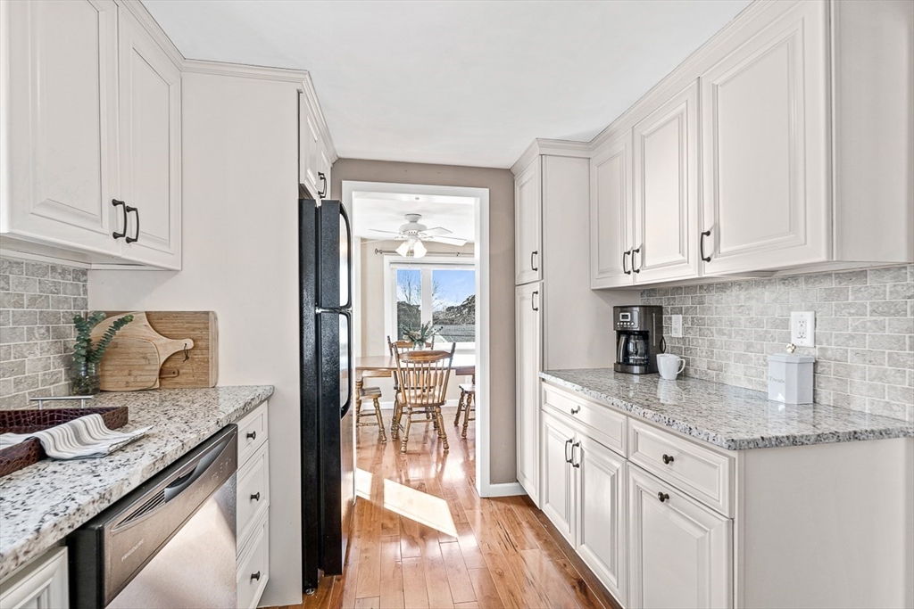 80 Neal Street Malden, MA 02148 - Photo 13 of 39 a kitchen with granite countertop a sink stove and cabinets