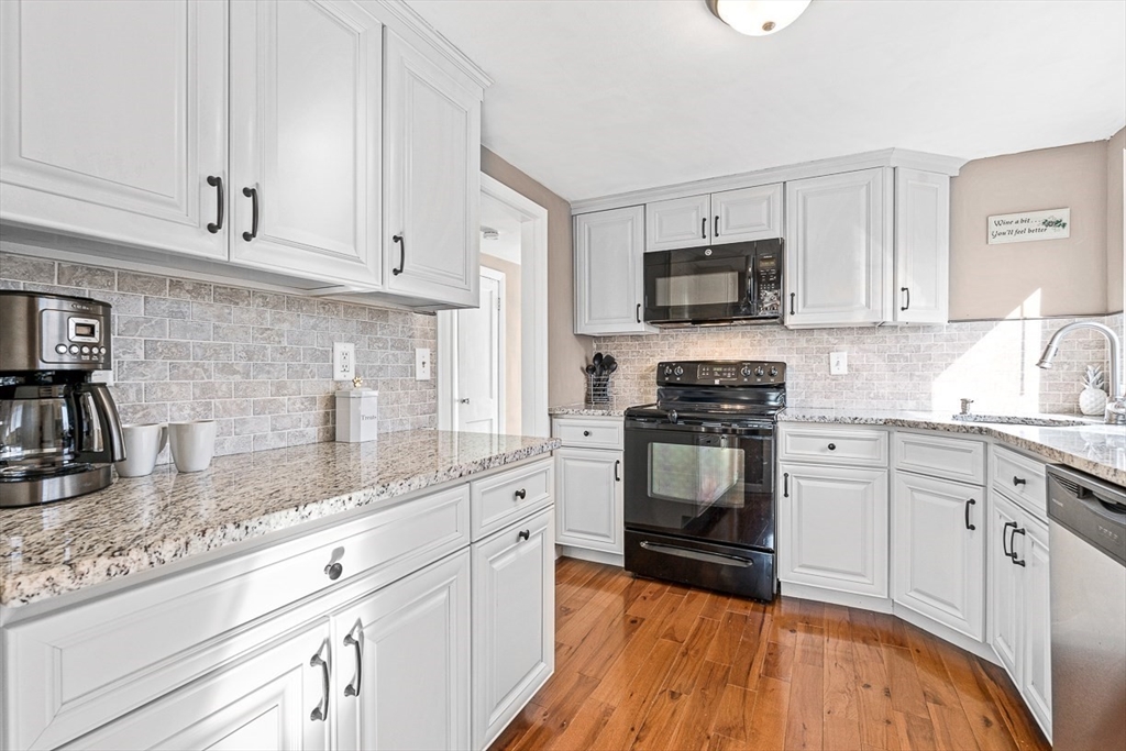 80 Neal Street Malden, MA 02148 - Photo 14 of 39 a kitchen with granite countertop a sink and steel appliances