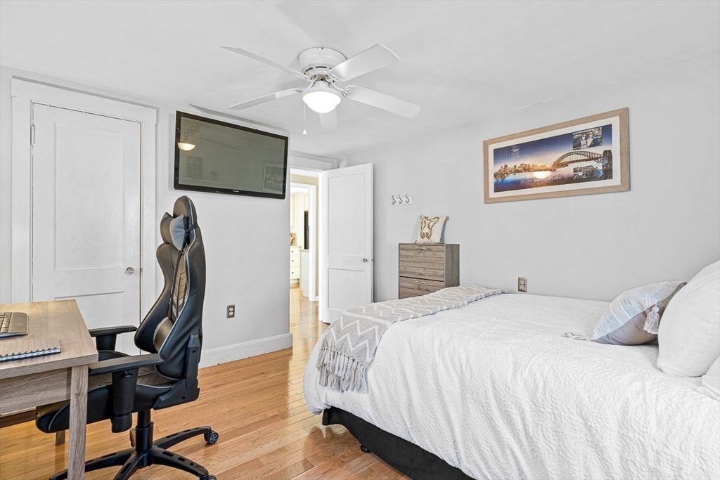 80 Neal Street Malden, MA 02148 - Photo 17 of 39 a bedroom with a bed desk and a flat screen tv