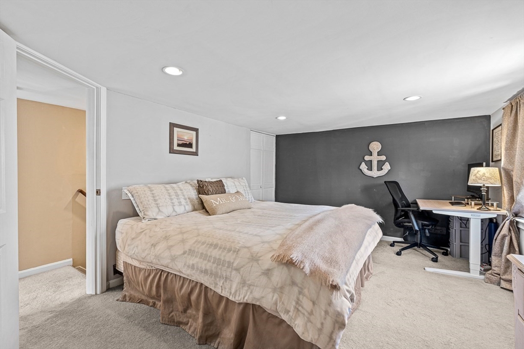 80 Neal Street Malden, MA 02148 - Photo 25 of 39 a bedroom with a bed and wooden floor
