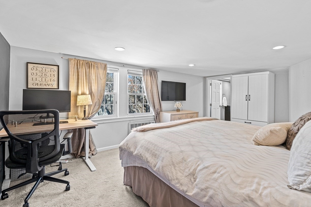80 Neal Street Malden, MA 02148 - Photo 26 of 39 a bedroom with a bed and a table in it