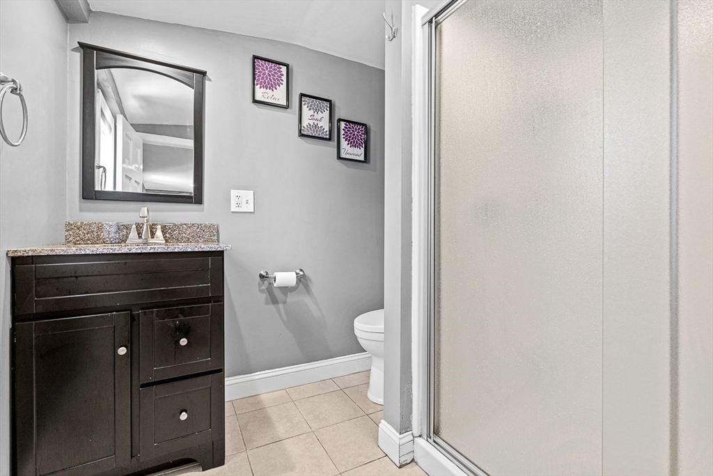 80 Neal Street Malden, MA 02148 - Photo 28 of 39 a bathroom with a sink a toilet and mirror