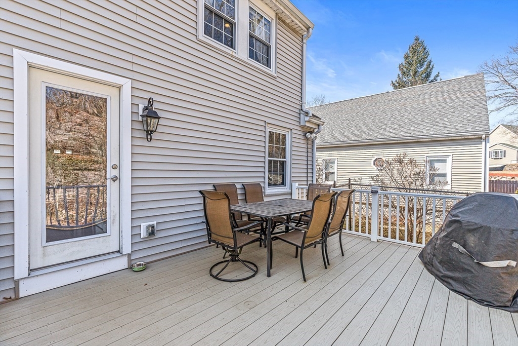 80 Neal Street Malden, MA 02148 - Photo 29 of 39 a roof deck with a table and chairs and wooden floor