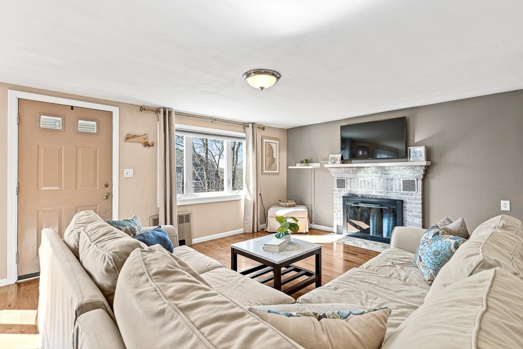 80 Neal Street Malden, MA 02148 - Photo 3 of 39 a living room with furniture a fireplace and a flat screen tv