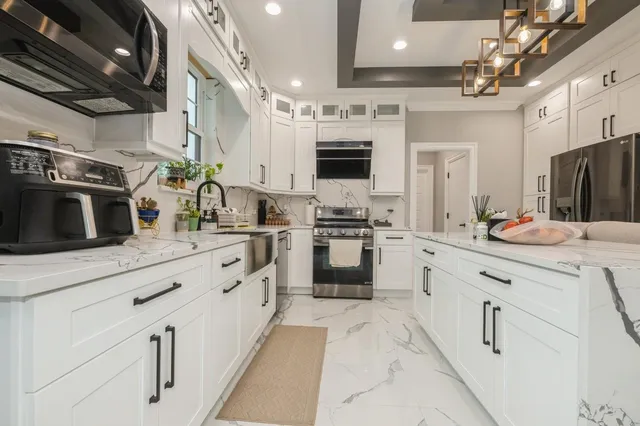 a kitchen with stainless steel appliances kitchen island granite countertop a sink and cabinets