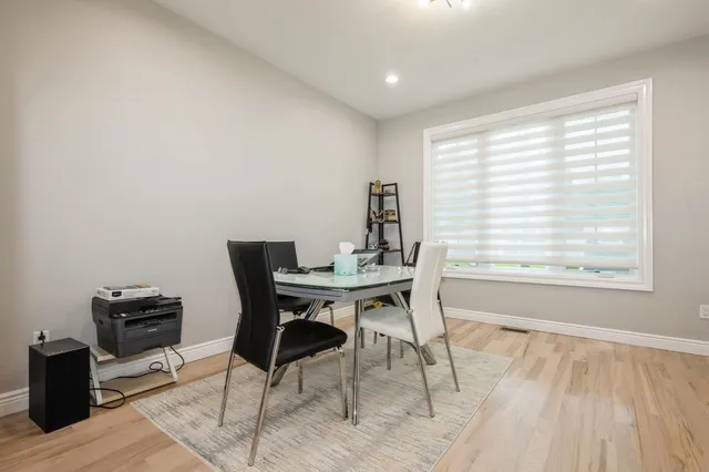 a kitchen with a dining table chairs a sink and cabinets