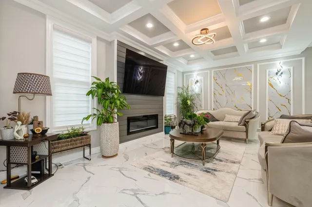 a living room with furniture potted plant and a fireplace