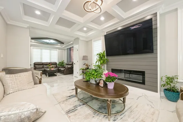 a living room with furniture a fireplace and a potted plant