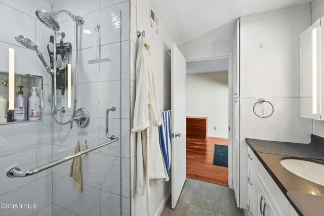 a bathroom with a shower and a sink