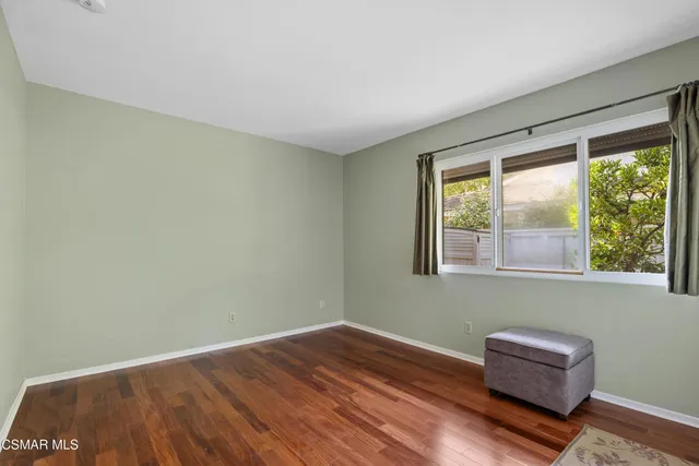 a room with a wooden floor and a window