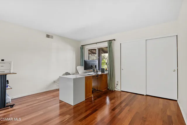 a view of living room with kitchen island wooden floor and window