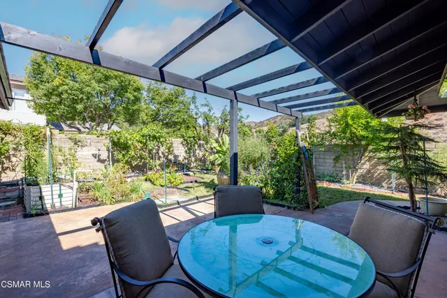a view of a porch with furniture and a yard