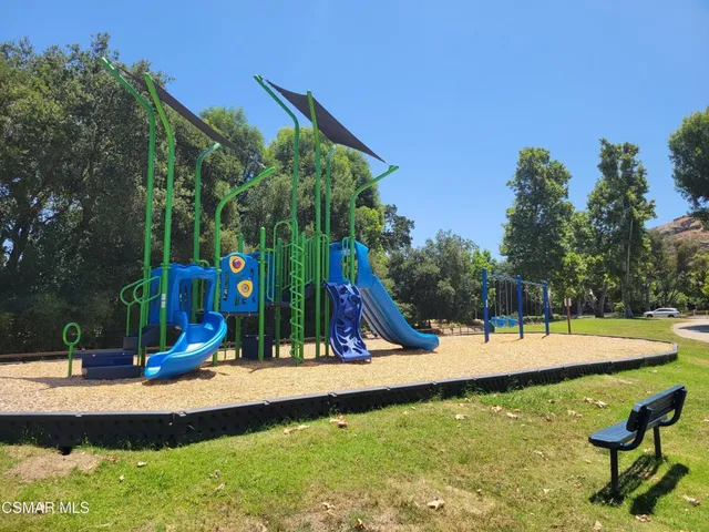 a view of a park with swings and slides