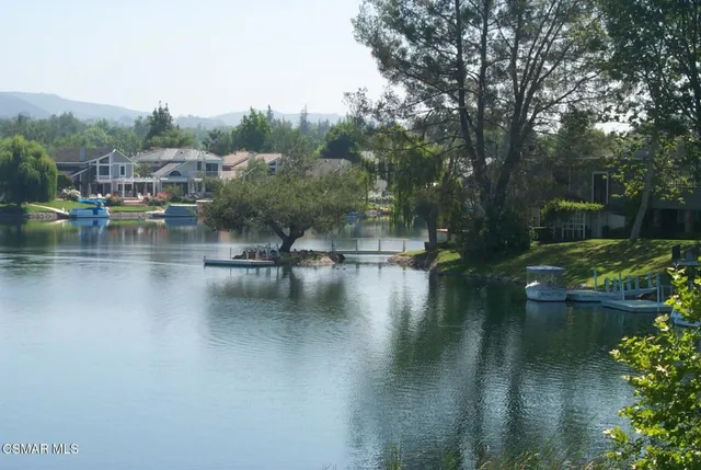 a view of river covered by trees and buildings