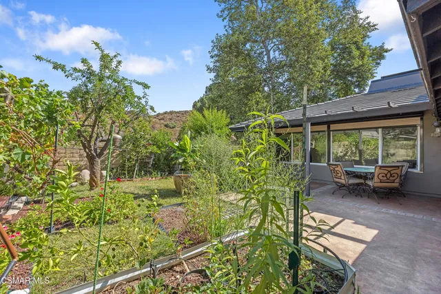 a view of backyard with seating area and green space