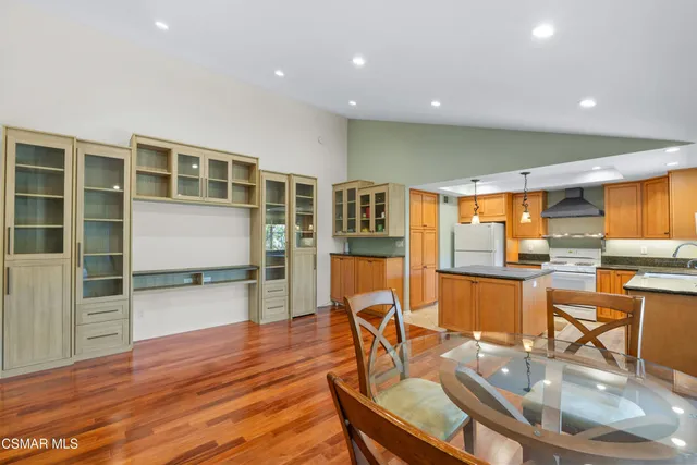 a dining room with furniture and wooden floor