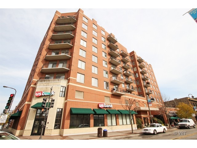 a view of a tall building next to a road
