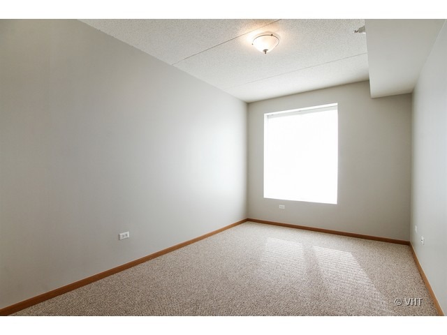 515 Main Street, Unit 507 Evanston, IL 60202 - Photo 8 of 10 a view of an empty room with a window
