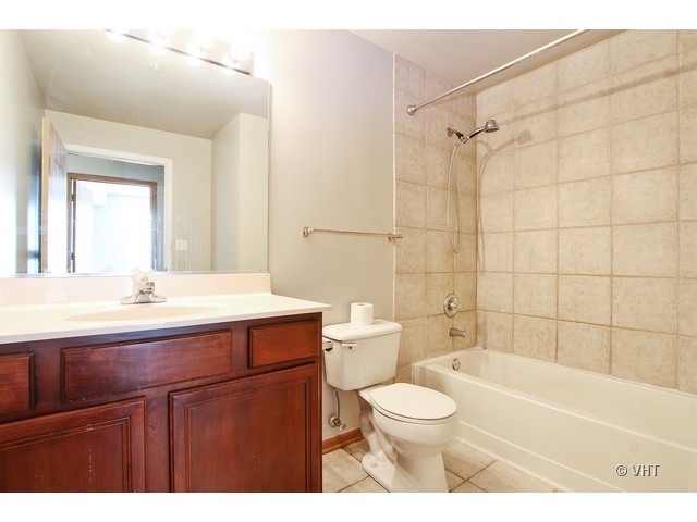 515 Main Street, Unit 507 Evanston, IL 60202 - Photo 9 of 10 a bathroom with a sink a toilet and shower
