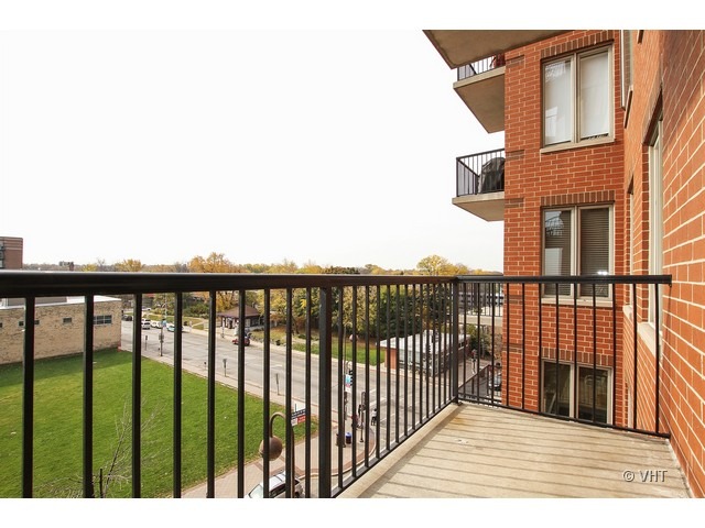 515 Main Street, Unit 507 Evanston, IL 60202 - Photo 10 of 10 a balcony of a house with wooden floor