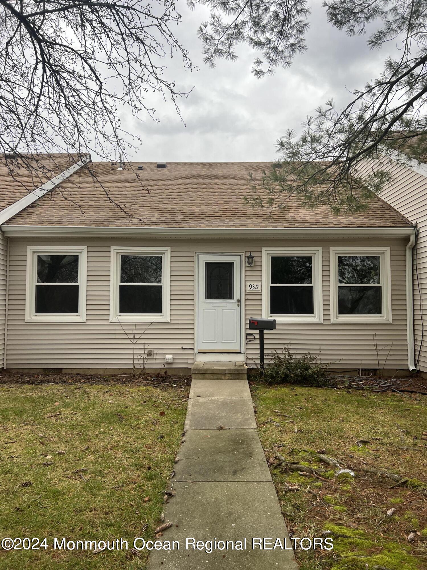 93 Halls Croft Road, Unit D Freehold, NJ 07728 - Photo 2 of 17 a front view of a house with a yard