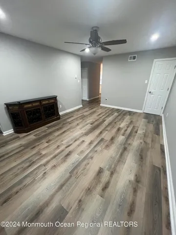 an empty room with wooden floor
