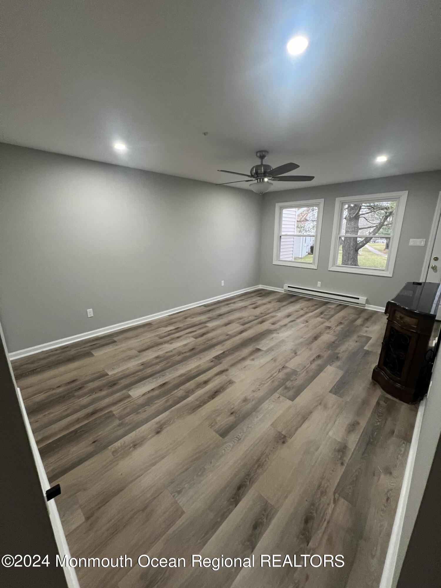 93 Halls Croft Road, Unit D Freehold, NJ 07728 - Photo 5 of 17 a view of empty room with windows