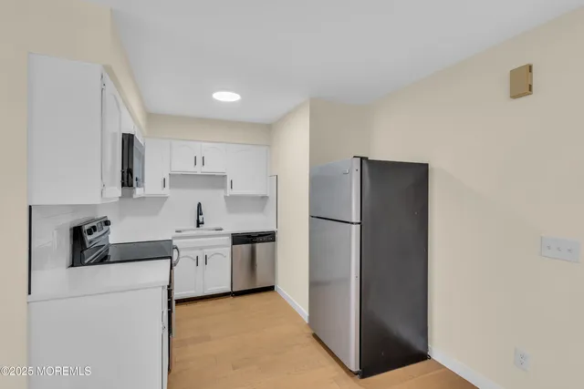 a kitchen with a refrigerator and a sink