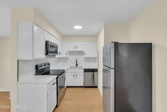 a kitchen with cabinets and stainless steel appliances