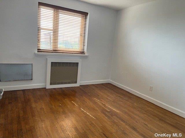 88-29 155th Avenue, Unit 6D Queens, NY 11414 - Photo 10 of 16 an empty room with wooden floor and windows